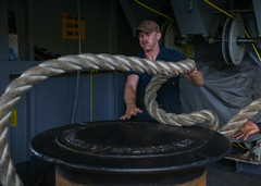 Boatswain’s Mate Seaman Buckley Mitchell, from Lake Hagerty City, Ariz., handles line on the fantail as the Nimitz-class aircraft carrier USS Abraham Lincoln (CVN 72) moors at Naval Base Guam for a port visit.