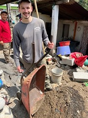 Michael Scanga empties one of many wheelbarrows full of dirt.