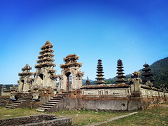 Sacred and mystical Ulun Danu Tamblingan water temple, with three towers and Balinese stone gates