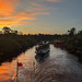 Houseboat and jungle river sunset