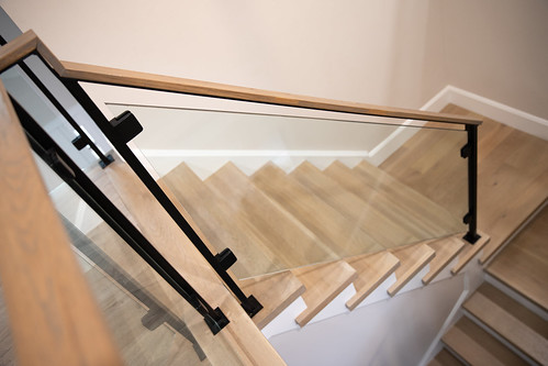 Modern stair, with glass panels + metal posts + wood handrail
