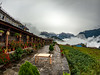 The overcast sky and the colorful Gurung cottage