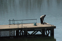 A Man Fishing On A Jetty In The River Duoro