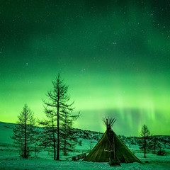 On the Yamal Peninsula in Siberia, the chum of an Indigenous Nenets family is illuminated by the aurora borealis.