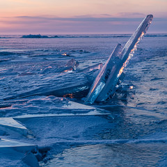 A winter sunrise at Lake Baikal in Siberia illuminates large shards of ice created during the early autumn thaw.