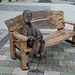 Man on bench, wood,  MCC
