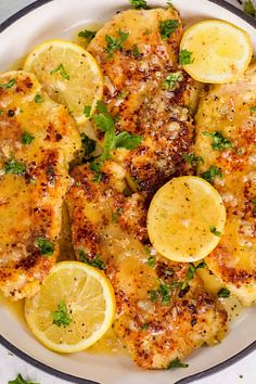 Quick and easy, 30-minute lemon chicken recipe with the most delicous garlic lemon butter sauce! The parmesan crusted crispy chicken breasts with the butter sauce is great for busy dinners. #lemonchicken #lemonchickenrecipe #chickendinner #natashaskitchen