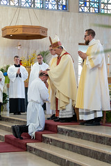 Bishop lays hands on the candidate.