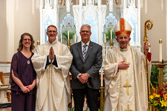 Fr. Cory Pius poses with his family and Bishop Persico.