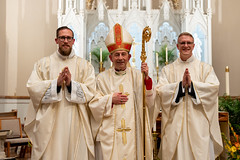 The newly ordained priests pose with Bishop Persico.