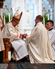 Bishop Persico anoints Deacon Chris Beran's hands with Sacred Chrism.