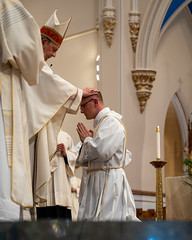 Bishop Persico lays hands on Deacon Cory Pius.