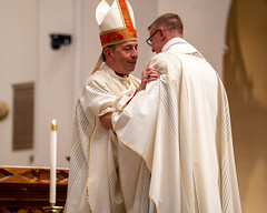 Bishop Persico offers newly ordained Fr. Cory Pius the fraternal kiss of peace.