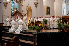 Priests lay hands on the ordinandi.