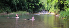 Samantha and Casper floating along the serene currents of Tat Luang waterfall