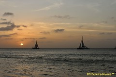 Two catamarans and the sunset in its last stage… in Aruba Island, in the Caribbean.