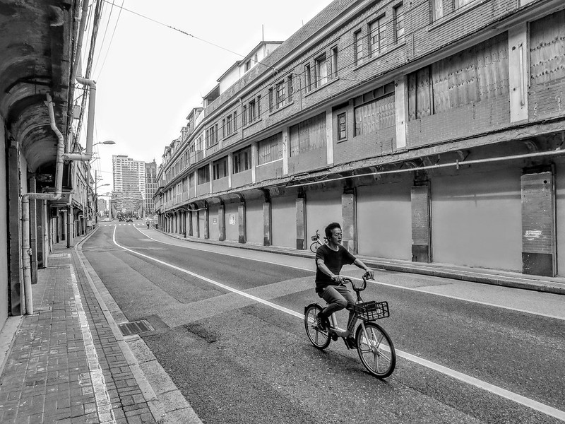 A man cycles through an empty street lined with old buildings that have been sealed off and are about to be demolished.<br/>© <a href="https://flickr.com/people/193575245@N03" target="_blank" rel="nofollow">193575245@N03</a> (<a href="https://flickr.com/photo.gne?id=53044749466" target="_blank" rel="nofollow">Flickr</a>)