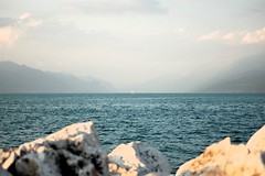 Yacht on the horizon, Lake Garda.  Taken from the Desenzano port breakwater.