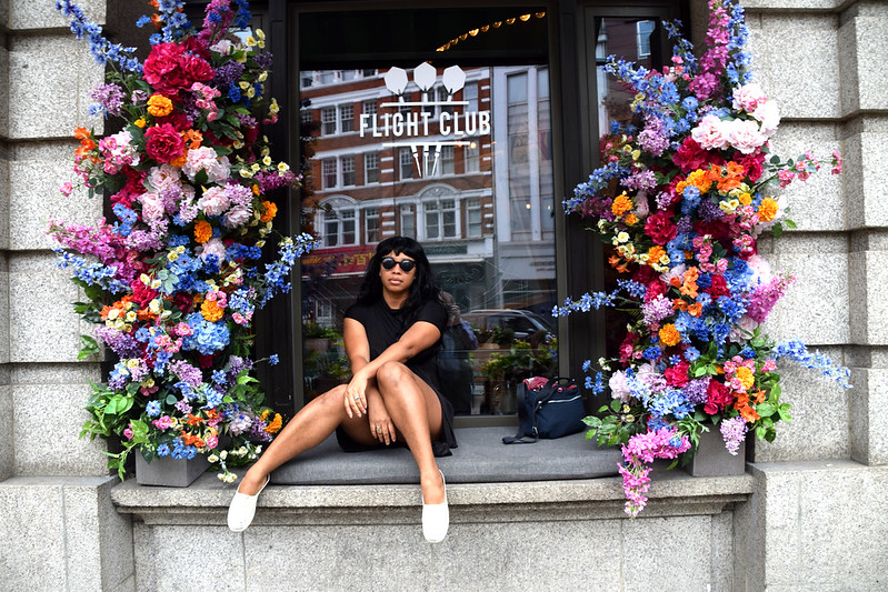 DSC_1756 Alesha Jamaican Model in Black Dress and Sunglasses on Location with Flower Display at The Fight Club City Road London<br/>© <a href="https://flickr.com/people/41087279@N00" target="_blank" rel="nofollow">41087279@N00</a> (<a href="https://flickr.com/photo.gne?id=53102176517" target="_blank" rel="nofollow">Flickr</a>)