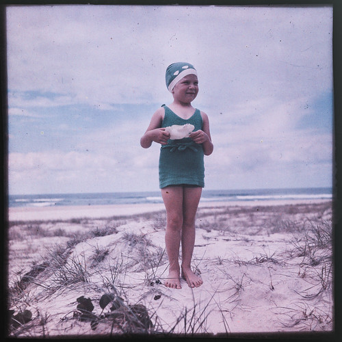 Young girl in her swimmers on the sand dunes of a Gold Coast beach in the 1940s