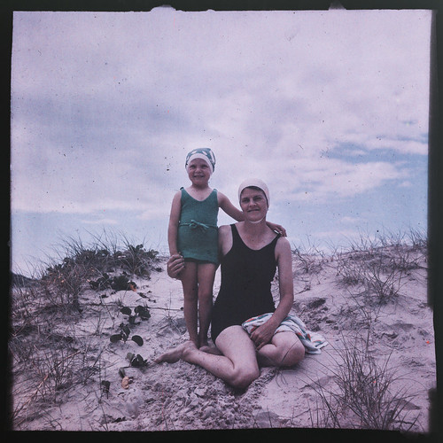 Woman and young girl in their swimmers on the sand dunes of a Gold Coast beach ca. 1945
