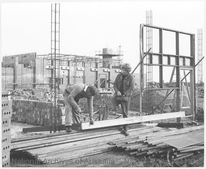 Two workers cutting timber, Glen Waverley Rehabilitation Centre, Springvale Road, Glen Waverley, 1971