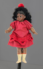 Black doll w/ red dress, c.1900