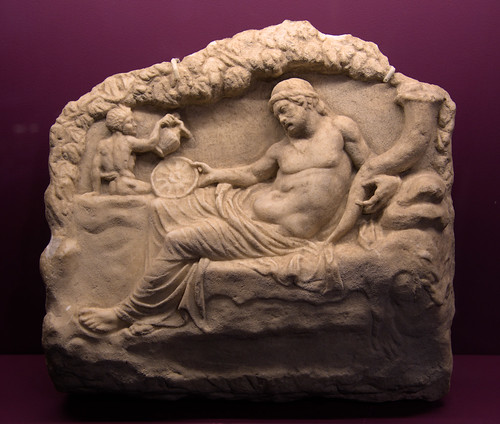 Greek marble relief of Dionysos reclining in a cave with cornucopia and phiale, from Policoro