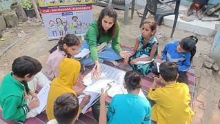 Blue Pen’s Volunteer pragya teaching english (months name) to kids of class 5th & 6th at munirka slums, today 19th Nov,23