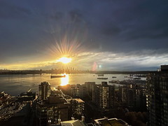 A brief sunburst over the Vancouver skyline