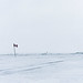 Canadian flag on ice and snow covered Lake Winnipeg in the Rural Municipality of Gimli, Canada