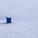 An ice fishing house on ice and snow covered Lake Winnipeg in the Rural Municipality of Gimli, Canada