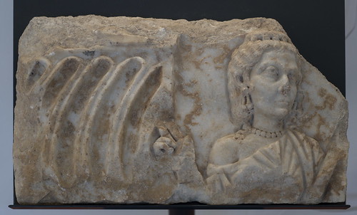 Fragment of a Roman strigillated sarcophagus with relief of the deceased woman, 1