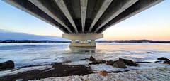 Under the Long Sault Bridge over the icy Ottawa River, near sunset