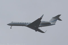 N223A - 2018 build Gulfstream G550, on approach to Runway 23R at a wet, grey Manchester