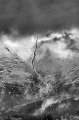 A small beck tumbles down the slopes of Skiddaw in this inclement and moody monochrome scene