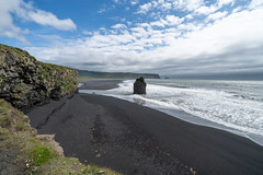 Dyrholaey area in Iceland with sea stacks and black sand beach