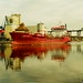 A red ship on the Kiel Canal near Rendsburg.