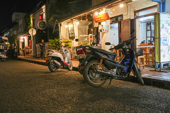 Nighttime street life with French colonial buildings in the historic old town of Luang Prabang, Laos Asia