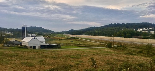 September 1, 2019: Farm buildings alongside Pennsylvania Turnpike as seen from North Center Street overpass bridge, New Stanton, Pennsylvania
