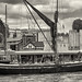 London, river Thames. The historic wooden barge "Hydrogen" (built in 1906) beneath the Tower of London.