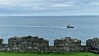 A returning small trawler passing Peel Castle on 04 April 2024