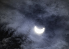 The smile of the Cheshire Cat (Alice in Wonderland) or the Solar eclipse burning through the thin cloudcover.