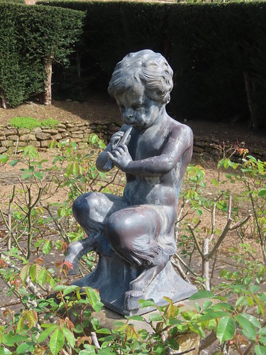 Pan statue in a hedged garden at Upton House and Gardens