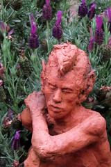 Pan sculpture with lavender flowers backdrop in the backyard of our San Francisco home 20180630-200713V