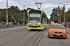 D2-class tram #3534 running a Route 16 service to Melbourne University heading across Princes Bridge with car and bicycle traffic, Melbourne