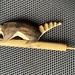 Reed whistle with Coati carving
