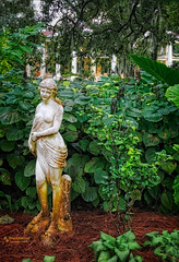 Female Statue in the garden with the plantation house in the background