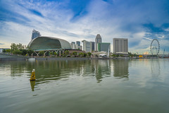 Marina Bay with reflections and  Esplanade - Theaters by the Bay and Singapore Flyer ferris wheel in Singapore