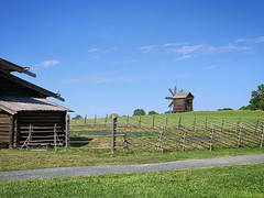 Rural landscape with a barn, fence and a windmill in Kizhi open-air museum, Karelia, Russia, June 2019